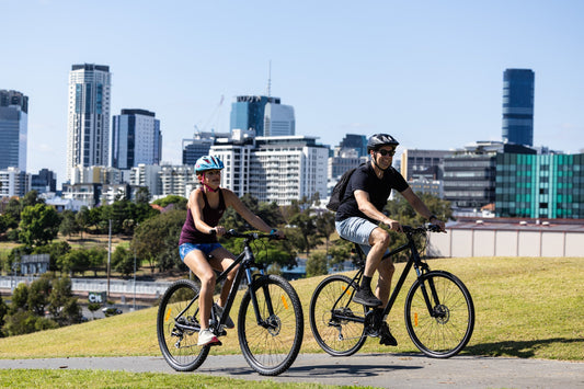 Gifts Dad Will Treasure: Real Ideas for Father’s Day. Daughter and dad cycling together. Outdoors fitness and fun.