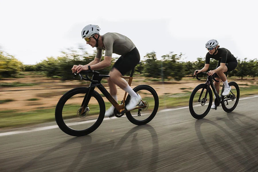 Two road cyclists in aerodynamic positions riding the new Merida REACTO bikes